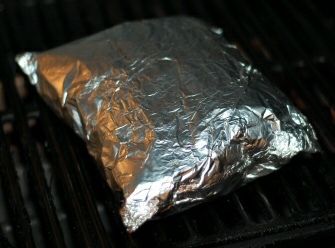 Grilling potatoes Grilling potatoes: the foil puffs up on the grill.